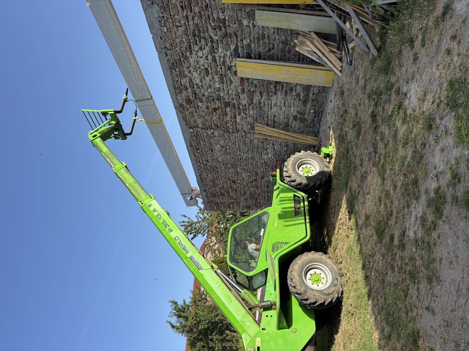 Levage d'une pièce de charpente au télescopique sur un chantier ATM